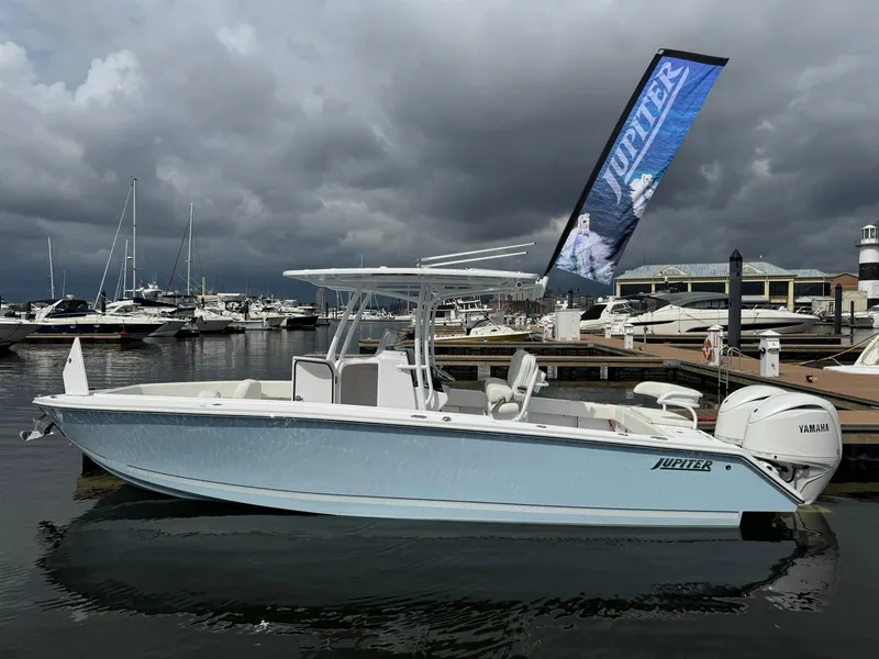 Slide: The Image of 2024 Jupiter 26 FS boat docked at marina under cloudy sky. - 1