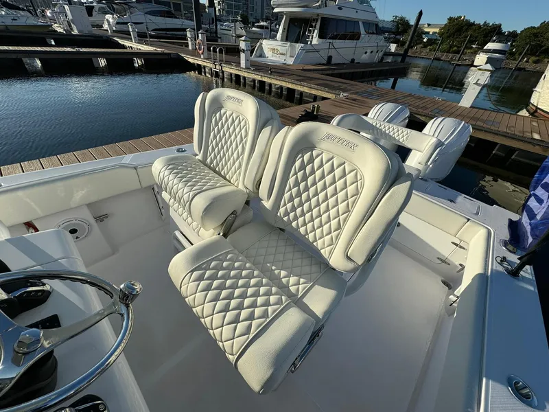 Slide: The Image of Luxurious seating on 2024 Jupiter 26 FS boat at marina dock. - 16