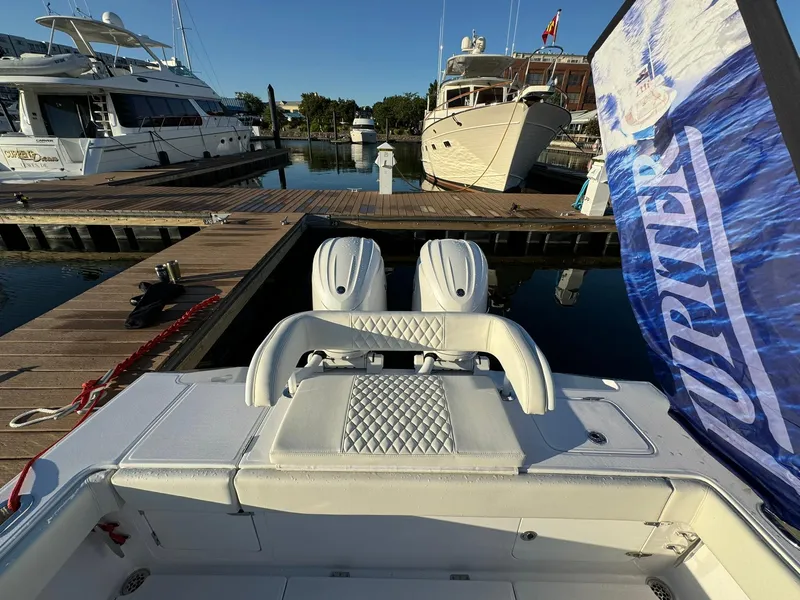 Slide: The Image of 2024 Jupiter 26 FS boat docked, featuring dual engines and luxurious seating. - 17