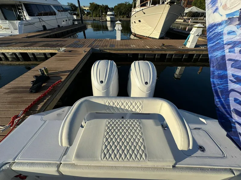Slide: The Image of 2024 Jupiter 26 FS boat with dual engines docked at marina. - 18