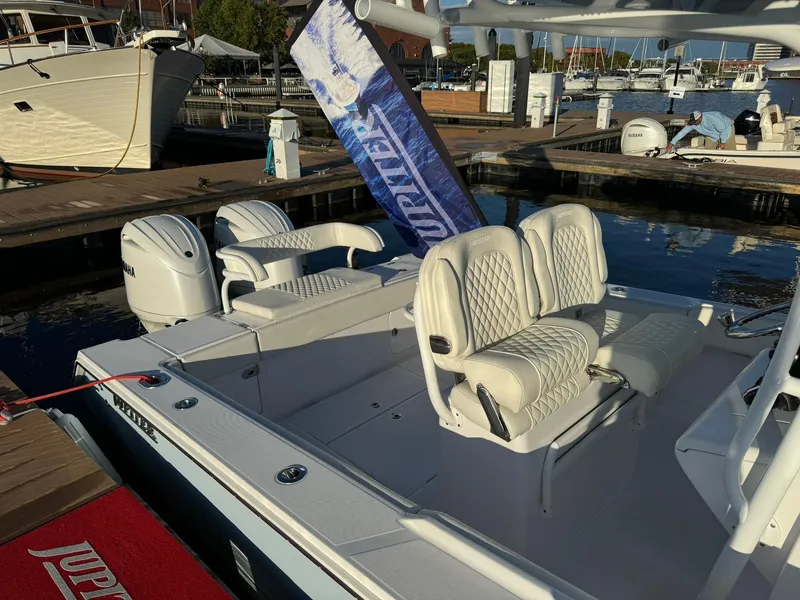Slide: The Image of 2024 Jupiter 26 FS boat with luxurious seating at a marina dock. - 20