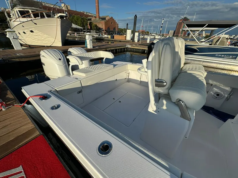 Slide: The Image of 2024 Jupiter 26 FS boat interior at marina, featuring sleek seating and modern design. - 5