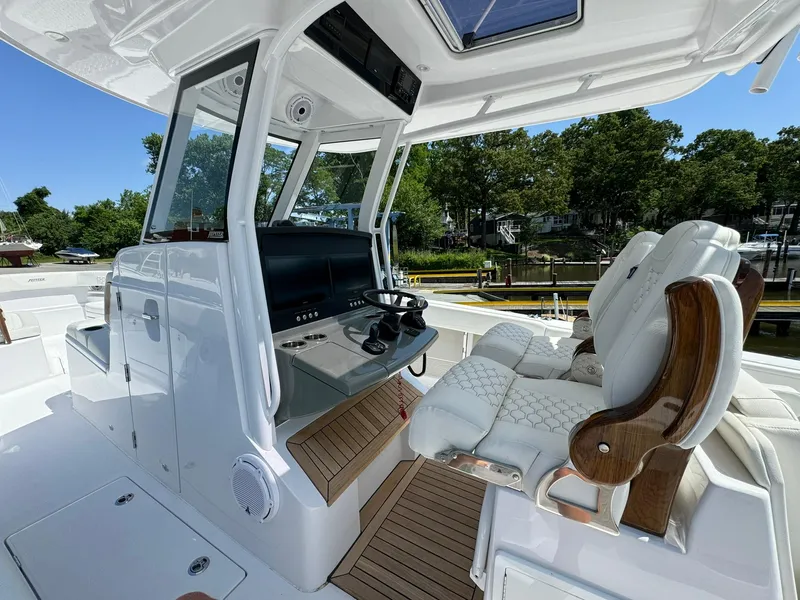Slide: The Image of 2024 Jupiter 340LS boat interior with luxurious seating and modern helm controls. - 14
