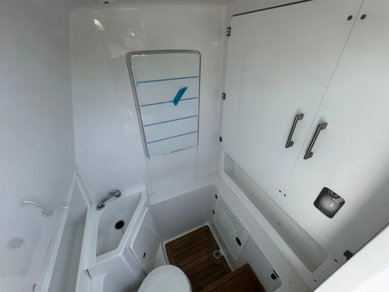 Slide: The Image of 2024 Jupiter 340LS boat bathroom with sink, mirror, and storage cabinets. - 22