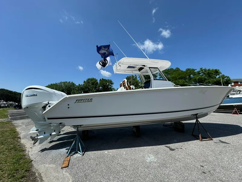 Slide: The Image of 2024 Jupiter 340LS boat on stands, Yamaha engine, clear sky background. - 4