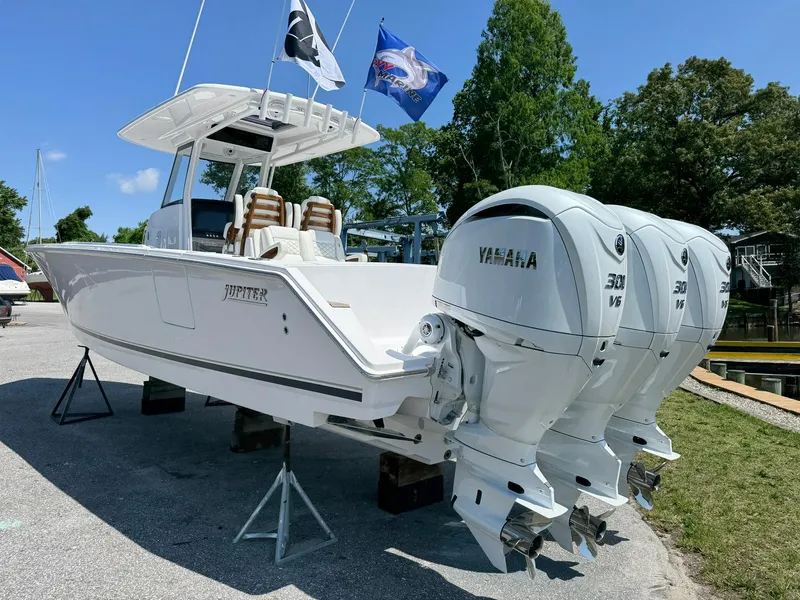 Slide: The Image of 2024 Jupiter 340LS boat with twin Yamaha 300 engines, displayed outdoors. - 7