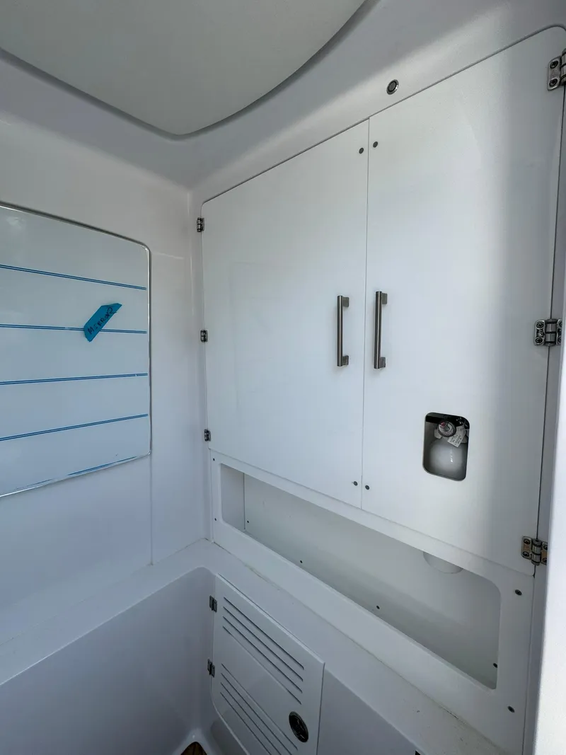 Slide: The Image of 2024 Jupiter 340LS interior with white cabinetry and modern fixtures. - 23
