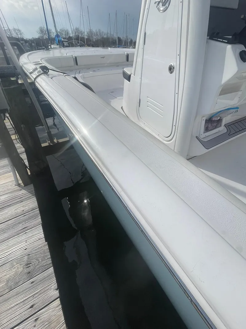 Slide: The Image of 2024 Tidewater 2500 Carolina Bay boat docked at marina under blue sky. - 10