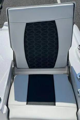 Slide: The Image of 2024 Tidewater 2500 Carolina Bay boat at marina, featuring seating and motor. - 11