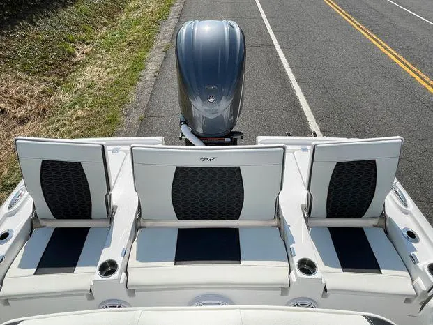 Slide: The Image of 2024 Tidewater 2500 Carolina Bay boat docked at marina under cloudy sky. - 14