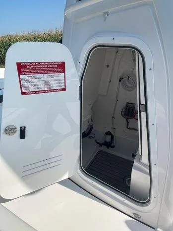 Slide: The Image of 2024 Tidewater 2500 Carolina Bay boat storage compartment open, showcasing spacious interior. - 22