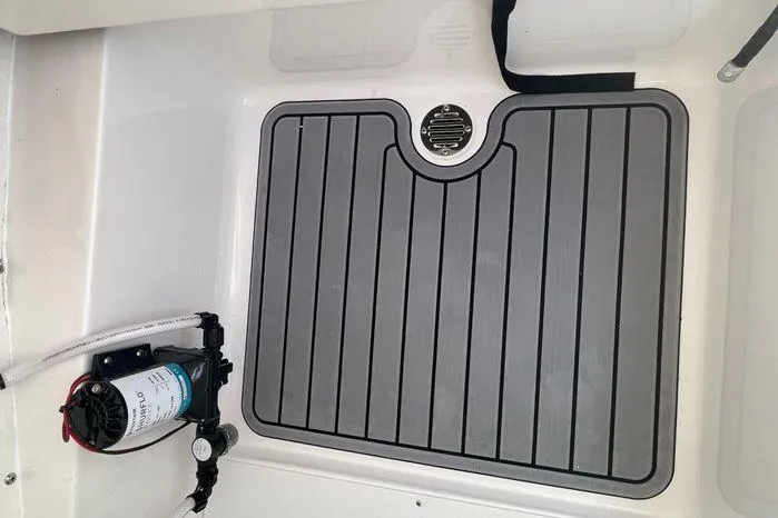 Slide: The Image of 2024 Tidewater 2500 Carolina Bay boat storage compartment with open hatch. - 23