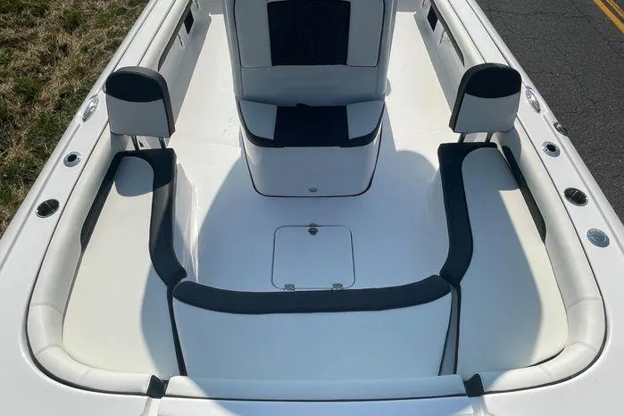Slide: The Image of 2024 Tidewater 2500 Carolina Bay boat interior with cushioned seating and storage compartments. - 25