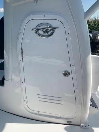Slide: The Image of 2024 Tidewater 2500 Carolina Bay boat console door with logo and sleek design. - 26