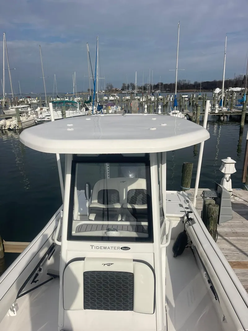 Slide: The Image of 2024 Tidewater 2500 Carolina Bay boat on calm water near marina. - 3