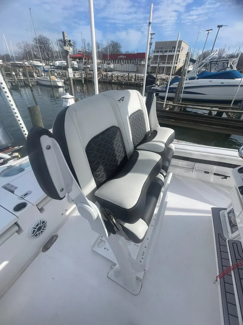 Slide: The Image of 2024 Tidewater 2500 Carolina Bay boat on calm water near marina. - 4