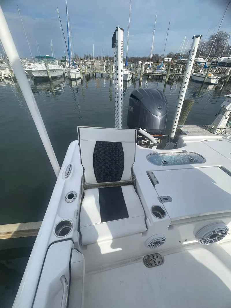 Slide: The Image of 2024 Tidewater 2500 Carolina Bay boat docked at a marina under a cloudy sky. - 6