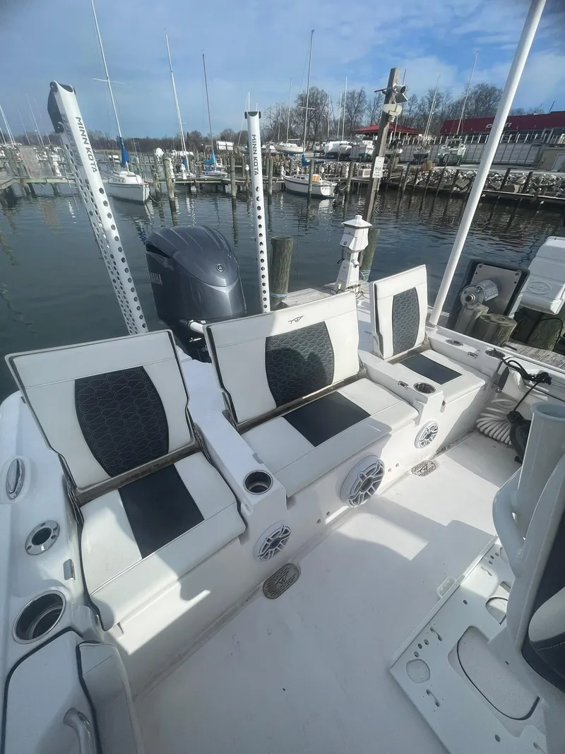 Slide: The Image of 2024 Tidewater 2500 Carolina Bay boat docked at a marina, showcasing sleek design and spacious deck. - 7