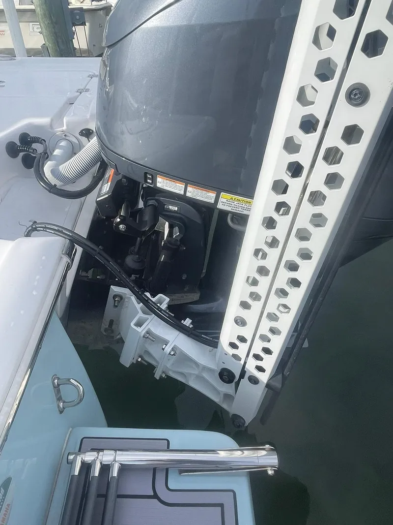 Slide: The Image of 2024 Tidewater 2500 Carolina Bay boat docked at a marina under a cloudy sky. - 8