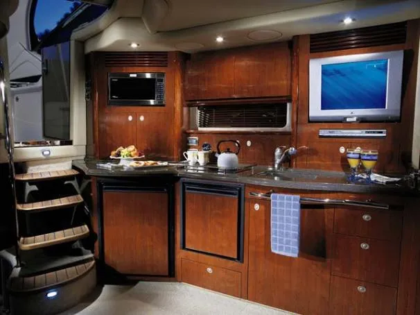 Slide: The Image of Interior of 2004 Sea Ray 390 Sundancer yacht with cozy seating and elegant decor. - 10