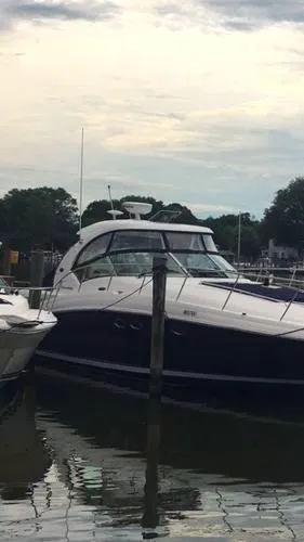 Slide: The Image of Luxurious 2004 Sea Ray 390 Sundancer yacht kitchen with modern amenities and sleek wood finish. - 11