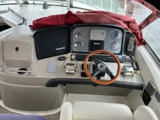 Slide: The Image of 2004 Sea Ray 390 Sundancer bathroom with toilet, sink, and porthole window. - 13