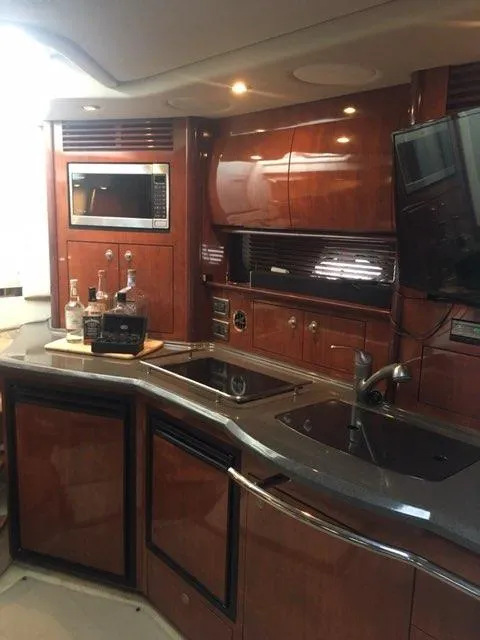 Slide: The Image of Interior of 2004 Sea Ray 390 Sundancer yacht with wood finishes and cozy seating area. - 17