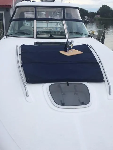 Slide: The Image of 2004 Sea Ray 390 Sundancer interior with brown leather seating and wooden accents. - 18