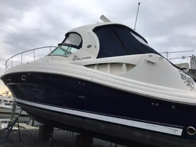 Slide: The Image of 2004 Sea Ray 390 Sundancer yacht docked at a marina under cloudy skies. - 2