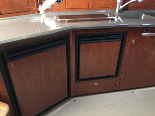 Slide: The Image of 2004 Sea Ray 390 Sundancer interior seating with white upholstery and black accents. - 29