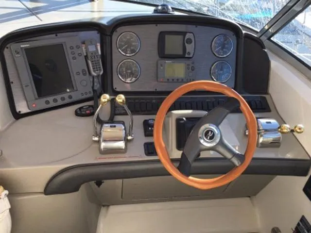 Slide: The Image of 2004 Sea Ray 390 Sundancer helm with modern controls and comfortable seating. - 35