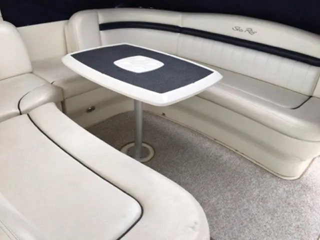 Slide: The Image of 2004 Sea Ray 390 Sundancer interior with kitchenette, TV, and wooden cabinetry. - 38