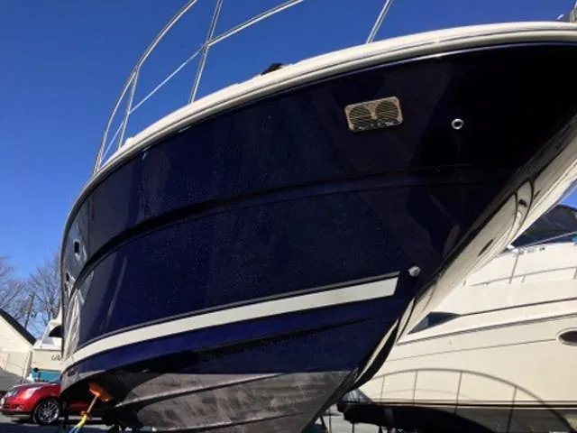 Slide: The Image of 2004 Sea Ray 390 Sundancer yacht docked at a marina under a cloudy sky. - 6