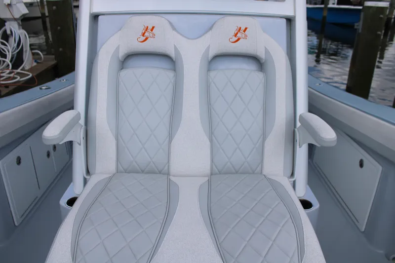 Slide: The Image of 2024 Yellowfin 36 Offshore boat seats with diamond stitching and armrests. - 13