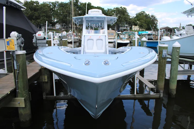 Slide: The Image of 2024 Yellowfin 36 Offshore boat docked at marina, front view. - 3