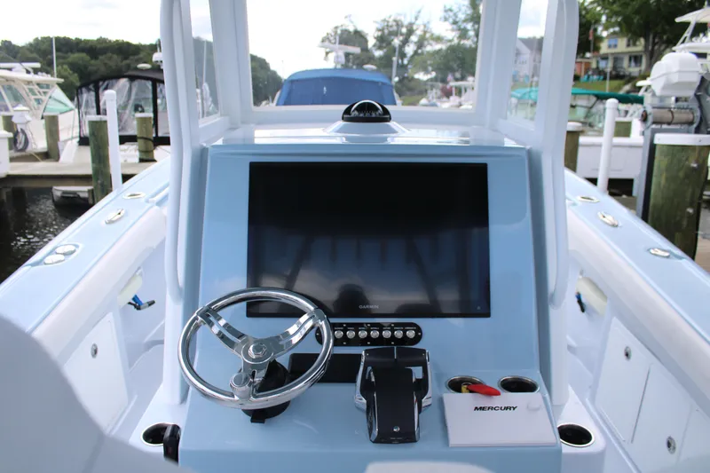 Slide: The Image of 2024 Yellowfin 36 Offshore boat console with steering wheel and Mercury controls. - 5