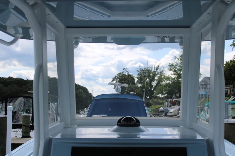 Slide: The Image of 2024 Yellowfin 36 Offshore boat interior view with marina backdrop. - 6