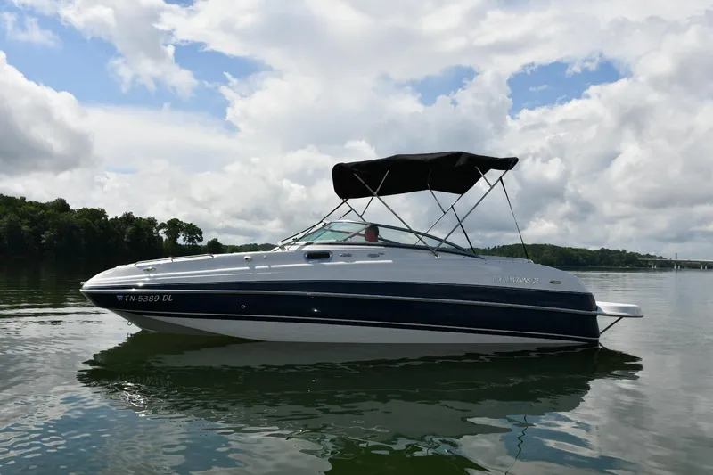 Slide: The Image of 2005 Four Winns 234 Funship boat on calm water under cloudy sky. - 0