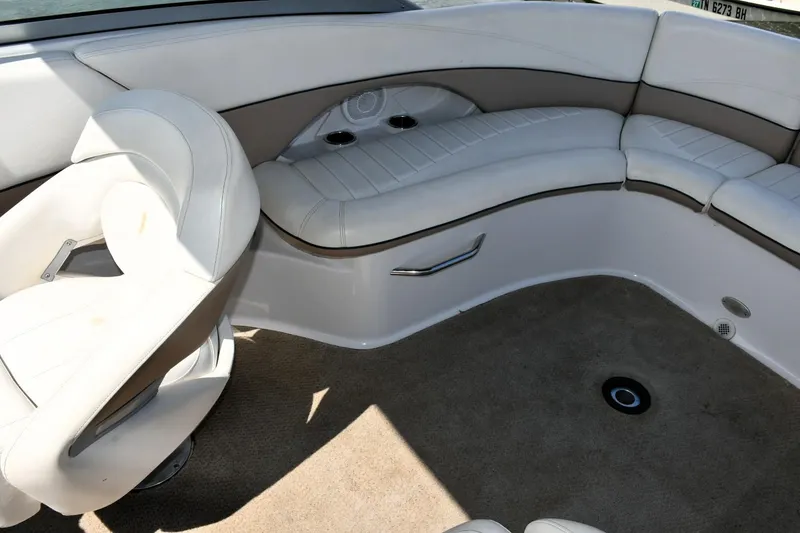 Slide: The Image of 2005 Four Winns 234 Funship interior with white seating and beige carpet. - 11