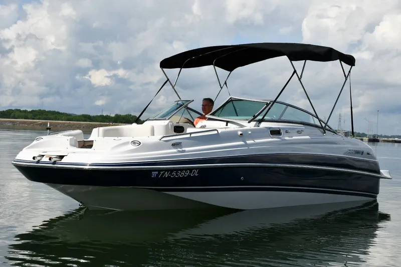Slide: The Image of 2005 Four Winns 234 Funship boat on calm water under cloudy sky. - 2