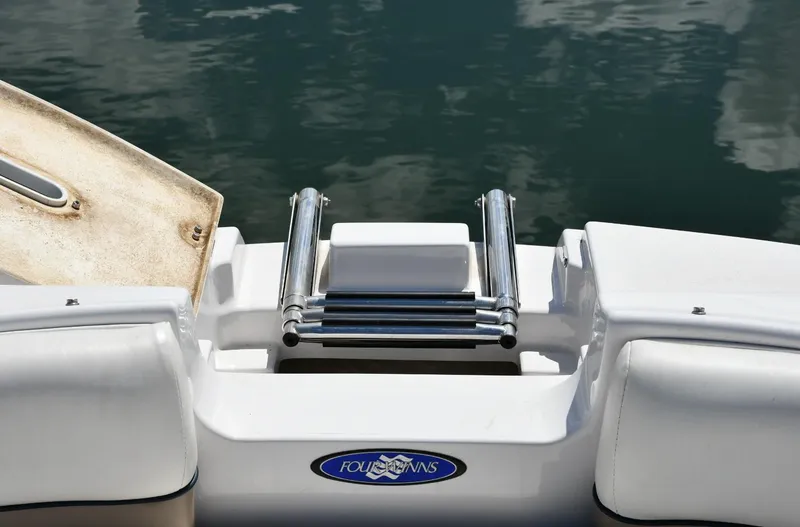 Slide: The Image of 2005 Four Winns 234 Funship boat ladder and platform on calm water. - 4