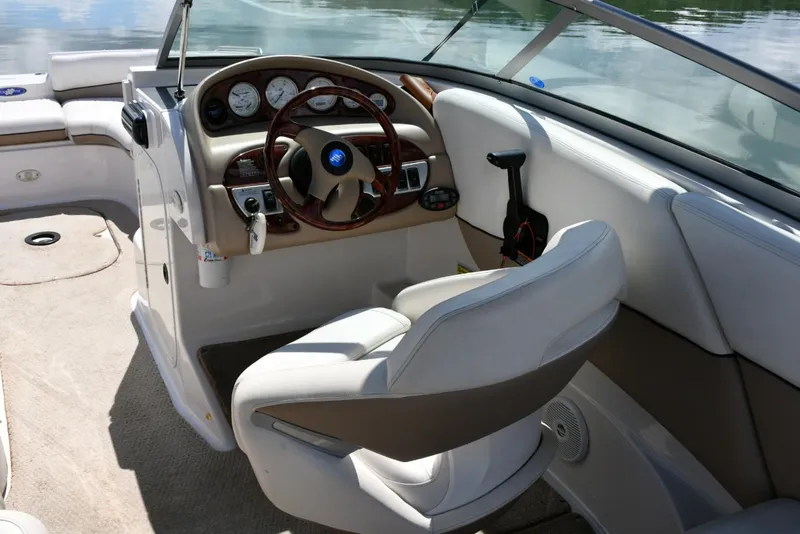 Slide: The Image of 2005 Four Winns 234 Funship boat interior with steering wheel and seating. - 7