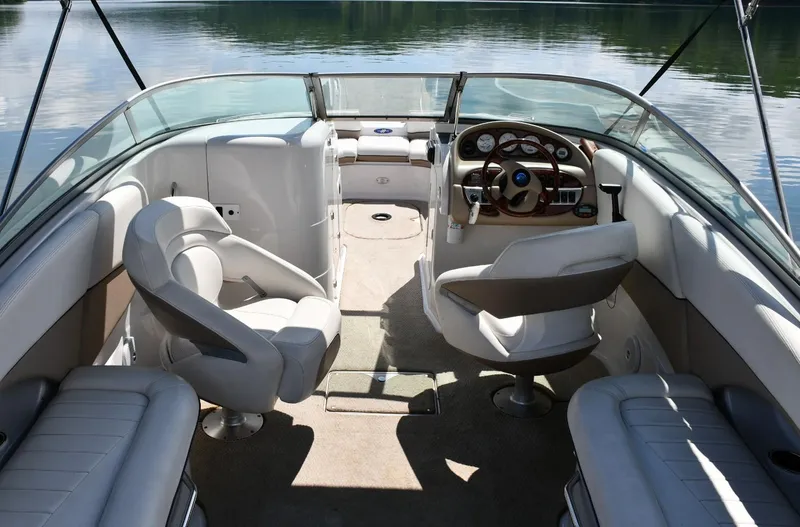 Slide: The Image of 2005 Four Winns 234 Funship boat interior with seating and steering wheel. - 8