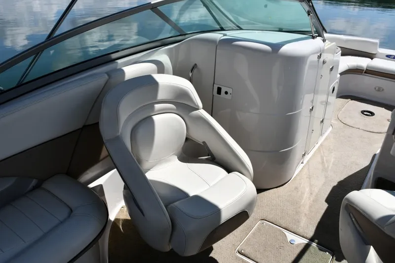 Slide: The Image of 2005 Four Winns 234 Funship boat interior with white seating and dashboard. - 9