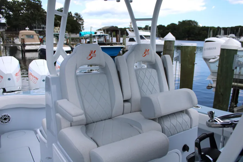 Slide: The Image of 2024 Yellowfin 36 Offshore boat with luxurious seating at a marina. - 9