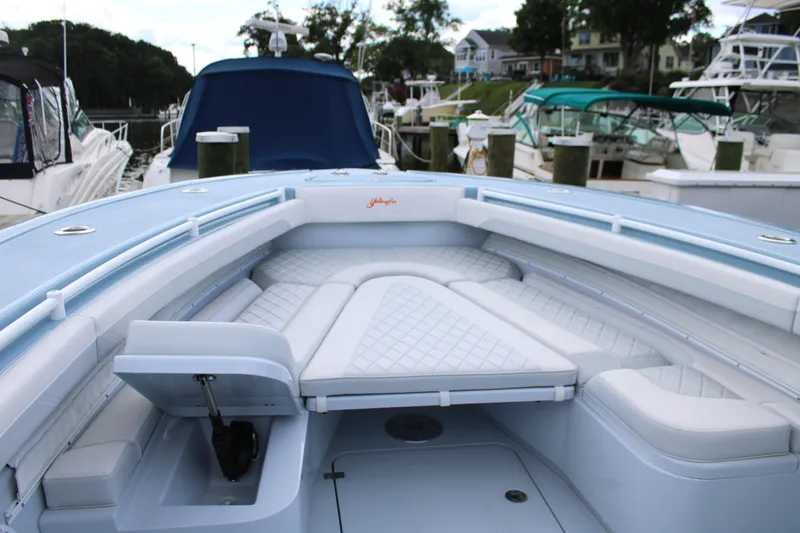 Slide: The Image of 2024 Yellowfin 36 Offshore boat with spacious seating at a marina. - 15