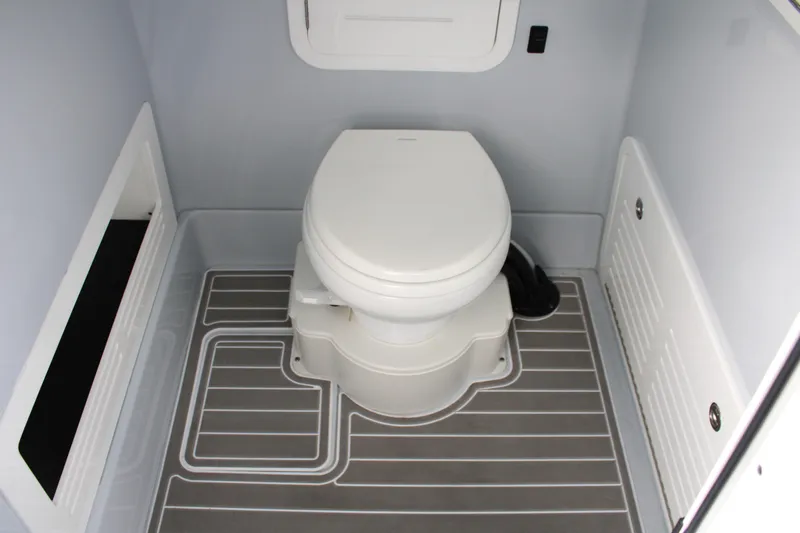 Slide: The Image of 2024 Yellowfin 36 Offshore boat bathroom with modern toilet and sleek flooring. - 23