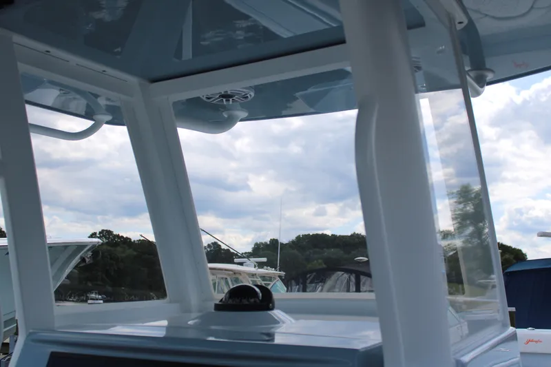 Slide: The Image of 2024 Yellowfin 36 Offshore boat interior with clear windows and scenic view. - 7