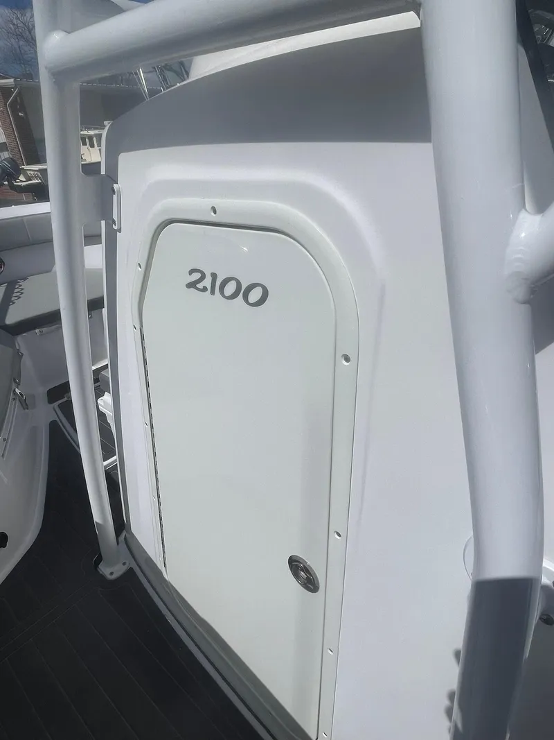 Slide: The Image of 2022 Aquasport 2100 CC boat, white side view with door detail. - 18