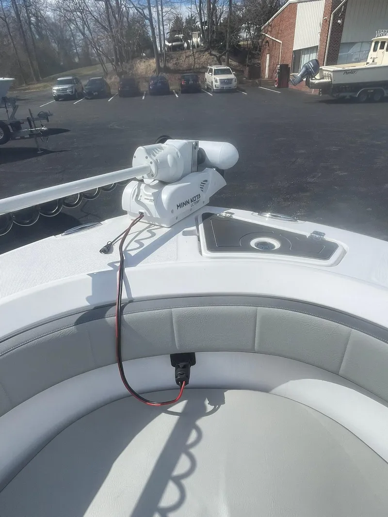 Slide: The Image of 2022 Aquasport 2100 CC boat with Minn Kota trolling motor in parking lot. - 21